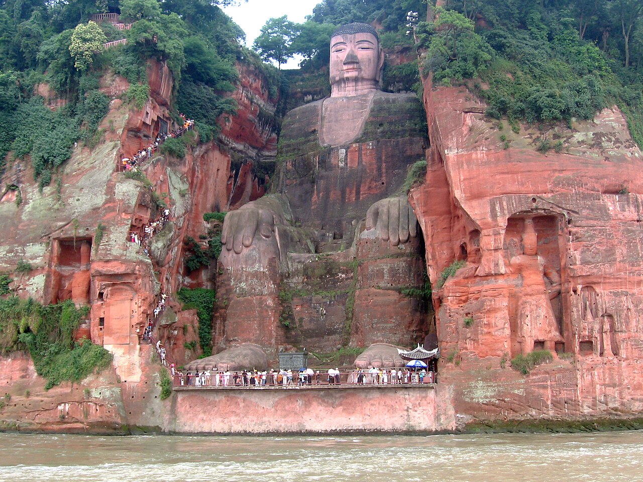 Leshan Giant Buddha carved into red sandstone cliff face along the Min River