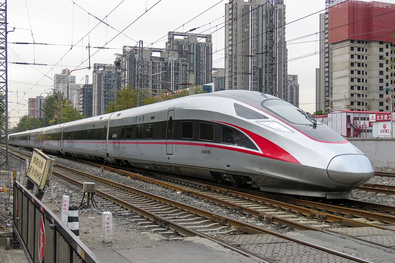 Modern high-speed bullet train traveling along scenic Yunnan mountain corridors