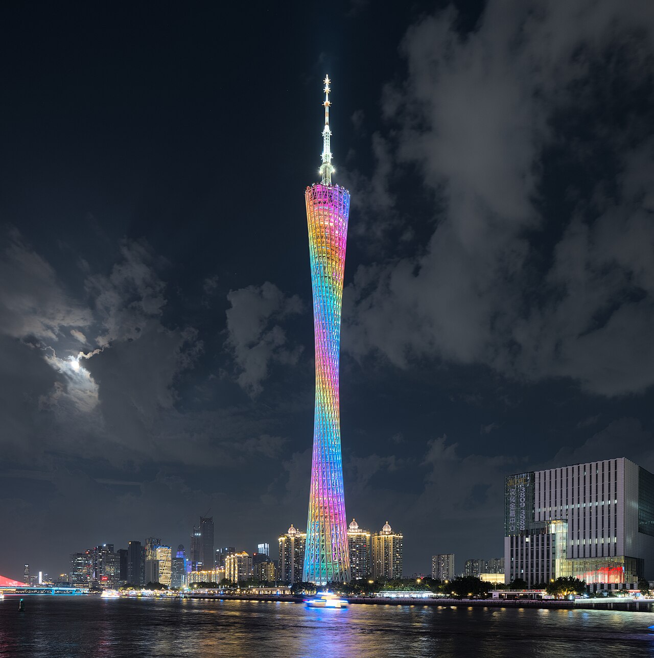 Rainbow-illuminated Canton Tower reflecting in the Pearl River at night in Guangzhou