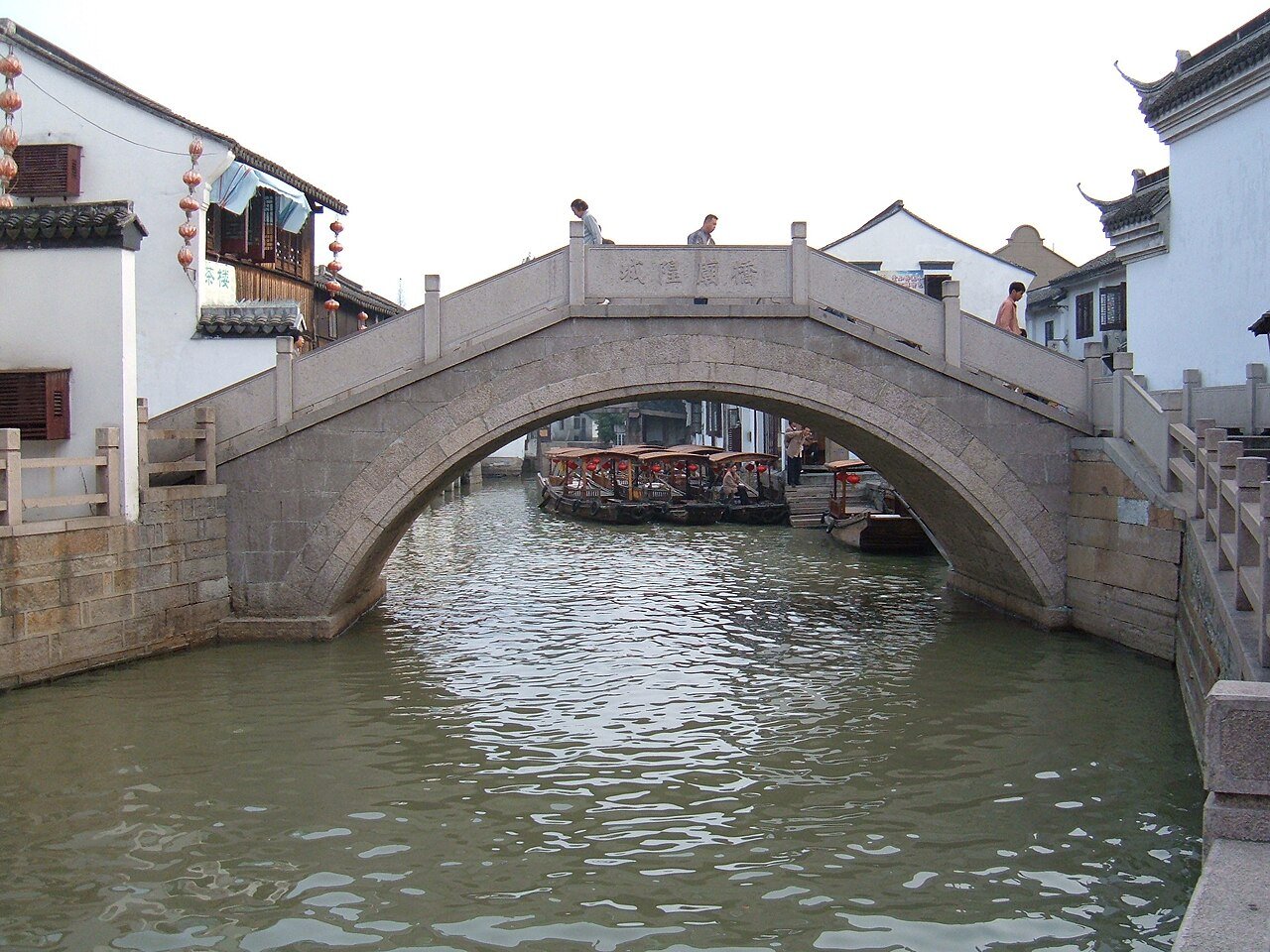 Traditional stone bridge and canal gondolas in Zhujiajiao water town near Shanghai