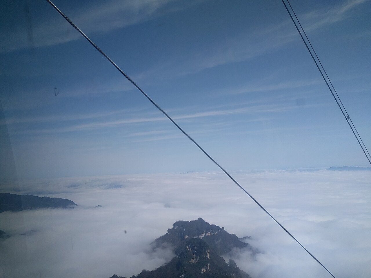 Area photo: Tianmen Mountain cable cars ascending over Yongding district near Hampton by Hilton